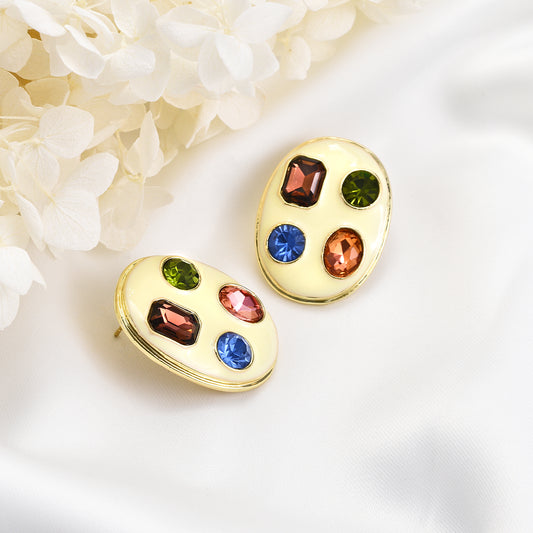 Fancy colorful jewels earrings on golden plaquette