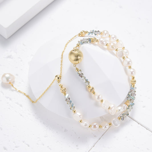 Eccentric golden necklace with white pearls and blue stones
