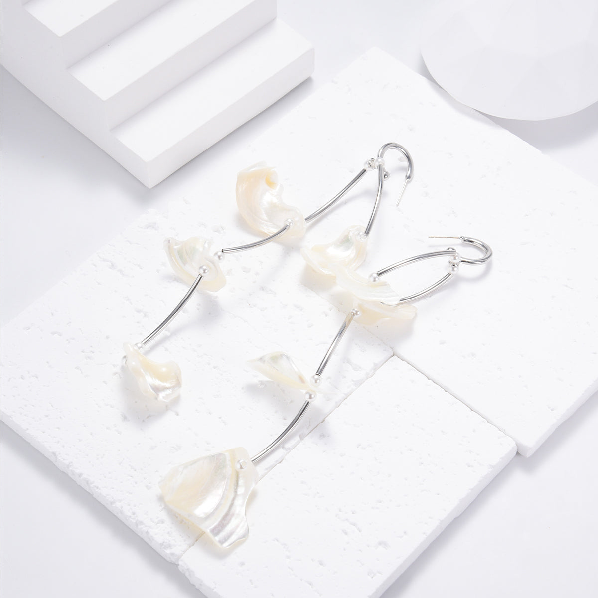 Lustrous silver sleek earrings featuring white shells