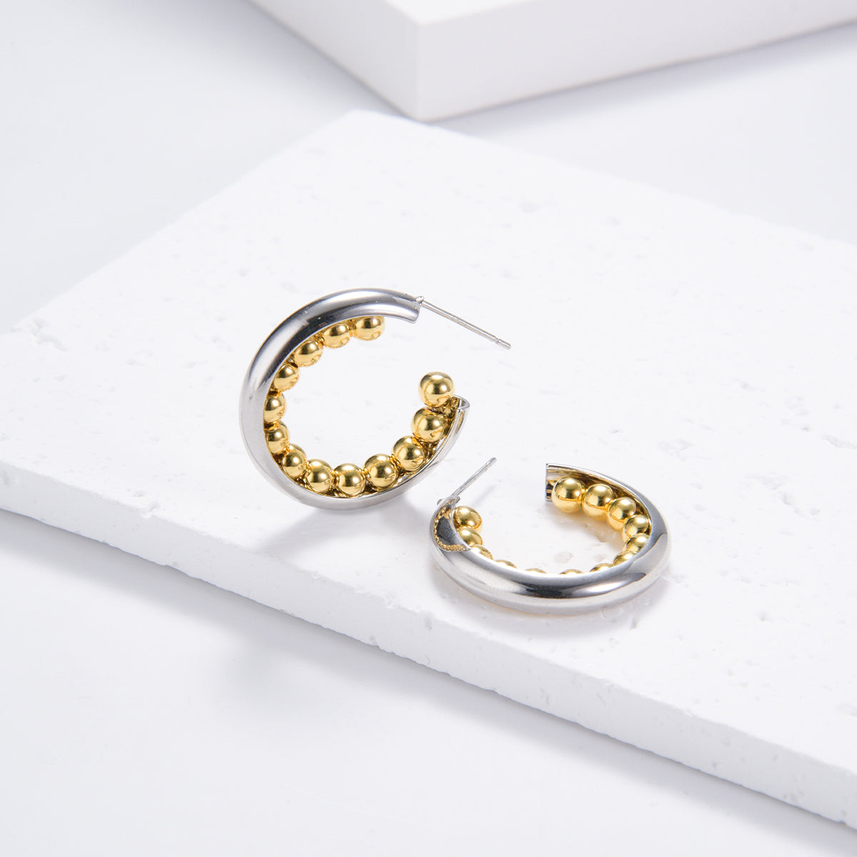 Golden beads on silver circular earrings