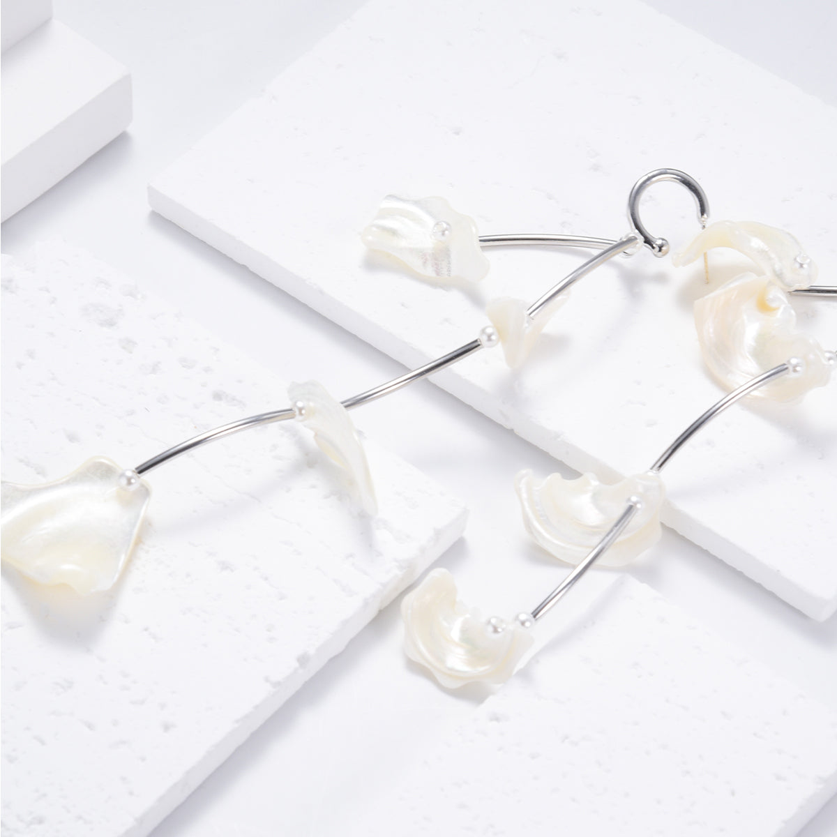 Lustrous silver sleek earrings featuring white shells