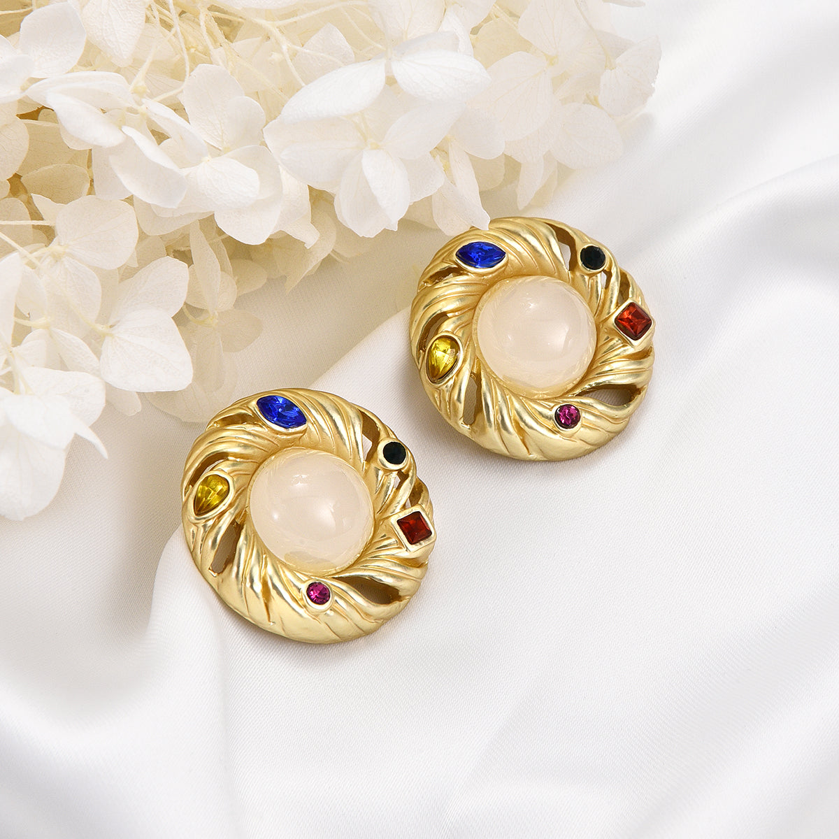 Ornate ivory mirror golden earrings with colorful jewels