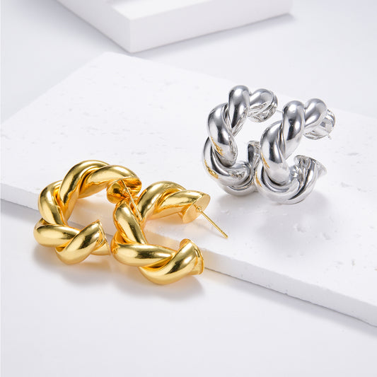 Twist-shaped gold and silver earrings