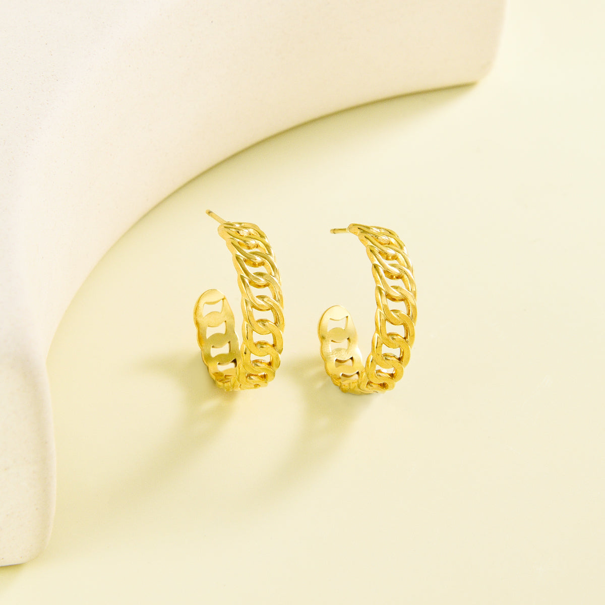 Small sized golden earrings with chain design