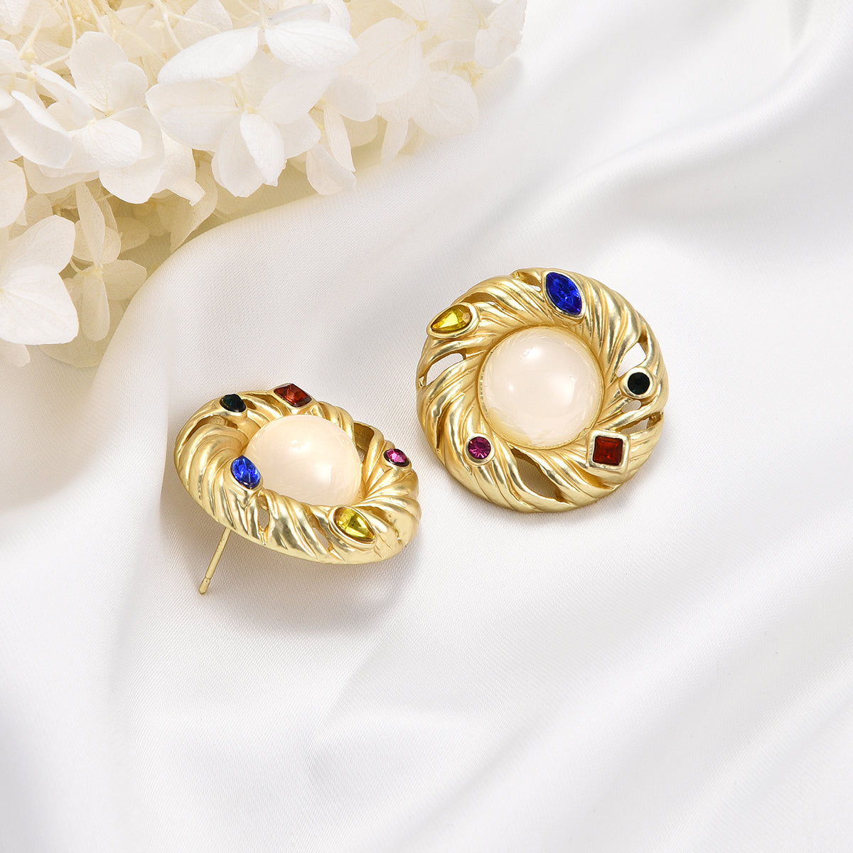 Ornate ivory mirror golden earrings with colorful jewels