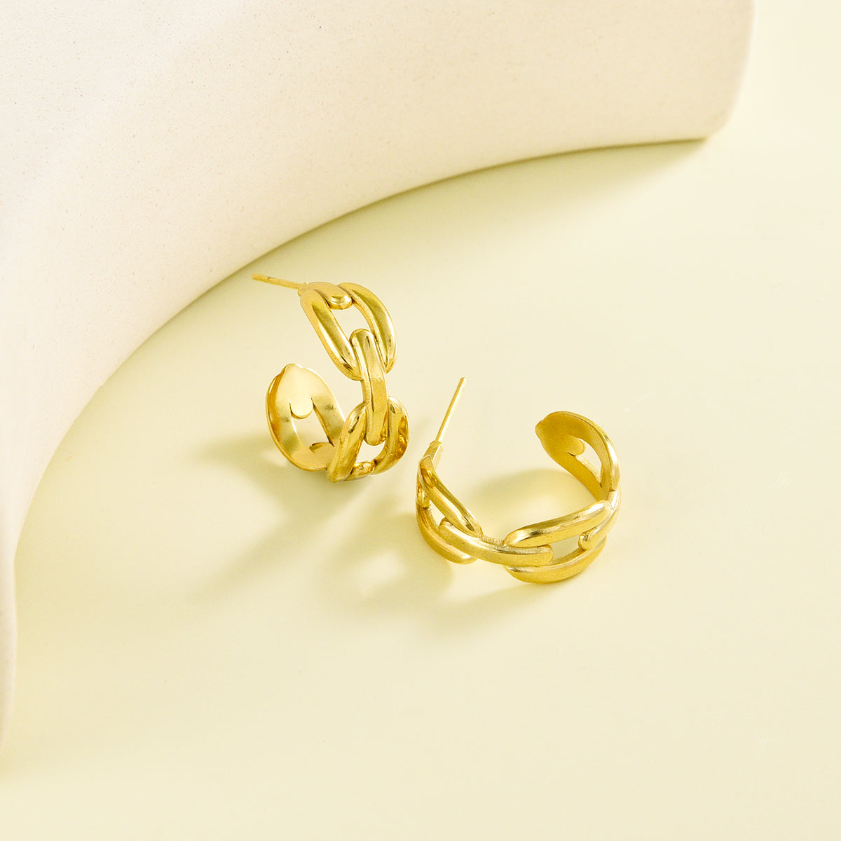Small sized golden earrings with spacious chain design