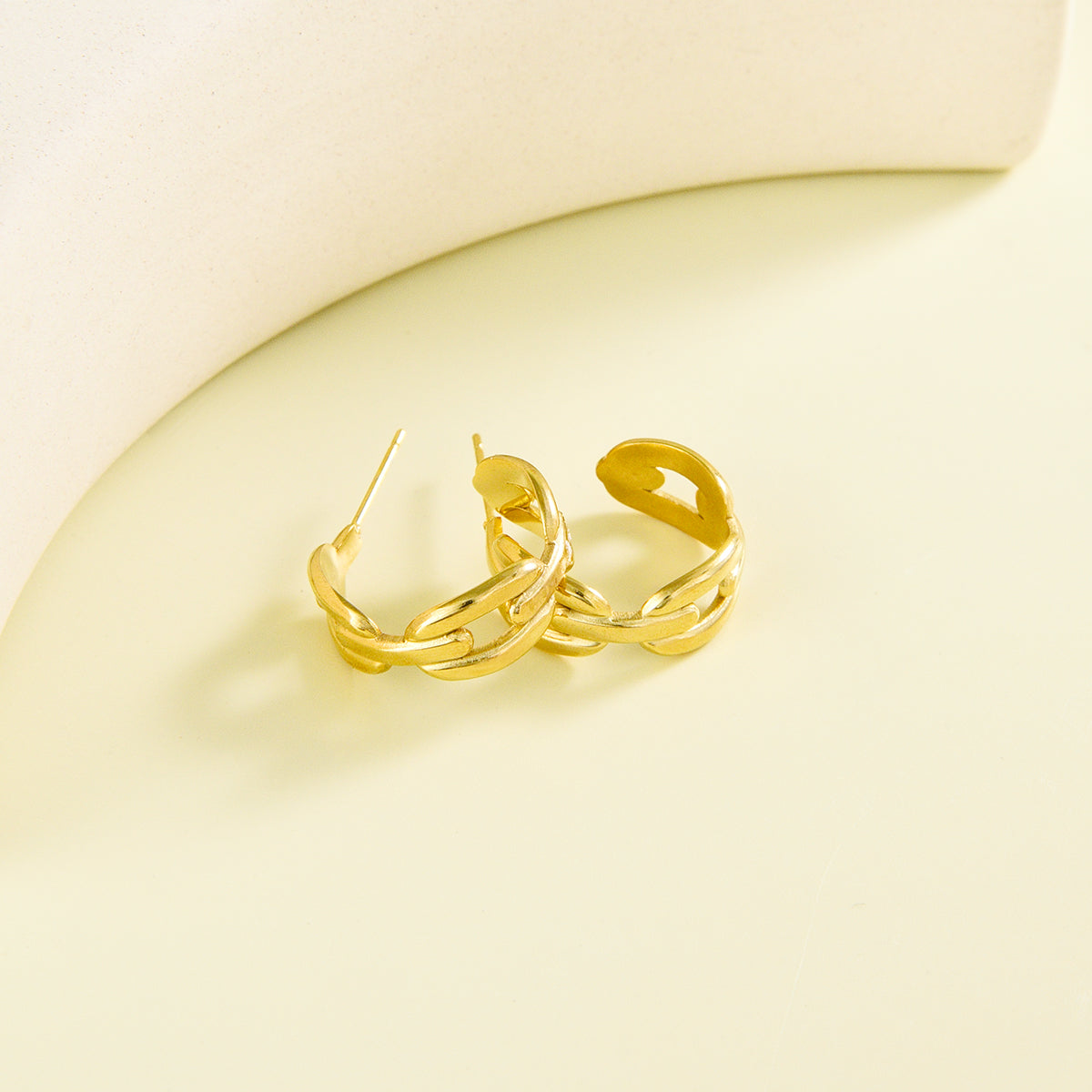 Small sized golden earrings with spacious chain design