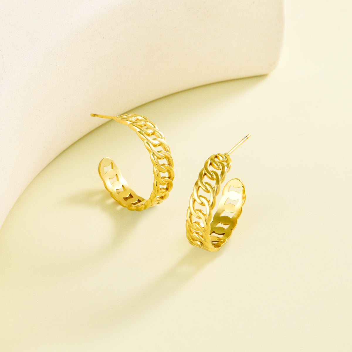 Small sized golden earrings with chain design